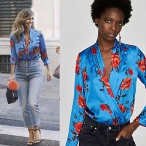 Wrap style v neck floral pattern bodysuit in blue and orange. Size small